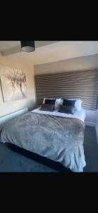 a bedroom with a large bed with a painting on the wall at Sea breeze house in Dog Island