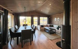 a living room with a table and a couch at Stunning Home In Gålå With Wifi in Gålå +5 photos