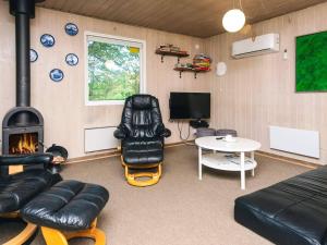 a living room with a couch and a fireplace at Tranquil Retreat in Bolilmark-By Traum in Bolilmark