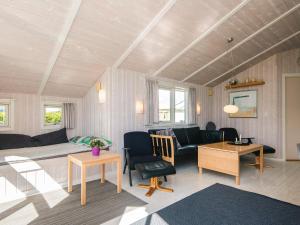 a living room with a couch and a table at 6 person holiday home in Haderslev-By Traum in Flovt