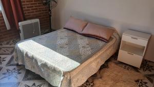 a bedroom with a bed with two night stands at LOS BULGAROS in Villa Cura Brochero +144 photos