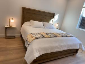 a bedroom with a large bed with a wooden headboard at Mountain Pines Getaway in Flagstaff