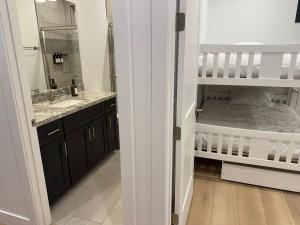 a bathroom with a sink and a bunk bed at Mountain Pines Getaway in Flagstaff +97 photos