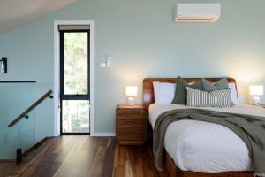 a bedroom with a large bed with blue walls at Elevated Modern Escape with Tennis Court Access in Grindelwald