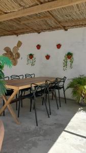 a wooden table and chairs in a room at Casa Mar in Cabo de Santo Agostinho