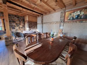 a room with a wooden table and chairs in a room at El terrenito in Zurumútaro +41 photos