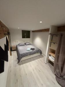 a bedroom with a bed and a flat screen tv at TheNest in Vienne