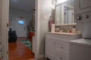 a white bathroom with a sink and a mirror at Centrally-Located Studio in DWTN Richmond in Richmond