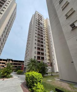 a tall white building with palm trees in front of it at PyMargal in Resistencia