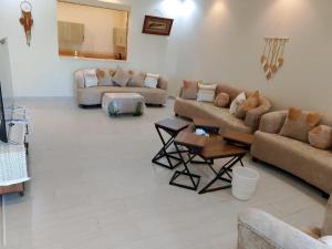 a living room with two couches and a table at ميراكي ريزورت , meraki resorts , durrat alarous , درة العروس in Durat  Alarous +5 photos