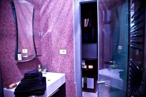 a purple bathroom with a sink and a mirror at Balcony Modern Apartment Near Opera and Cascade, Middle of City Center in Yerevan +20 photos