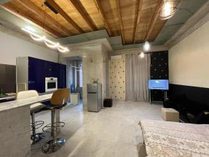 a large room with a kitchen and a living room at Balcony Modern Apartment Near Opera and Cascade, Middle of City Center in Yerevan