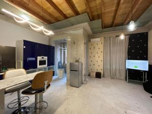 a kitchen with a counter and chairs in a room at Balcony Modern Apartment Near Opera and Cascade, Middle of City Center in Yerevan