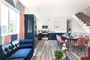 a living room with a blue couch and a table at Central 4BR Townhome Modern Perks in Los Angeles