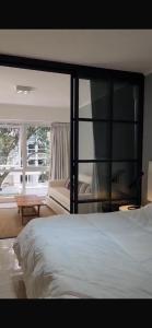 a bedroom with a large bed and a window at Green Park hermoso apartamento vista al lago in Punta del Este