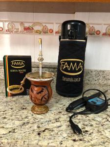 a counter top with a cup of coffee and a bag of food at Luz da Catedral in Santo Ângelo +6 photos