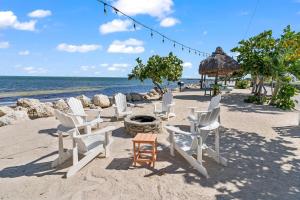 a group of chairs and a fire pit on the beach at Saltwater Lagoon Front View, Marina, Kayaks in Key Largo