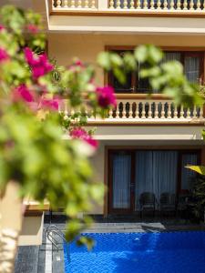a hotel with a swimming pool in front of a building at Lys Homestay in Ninh Binh