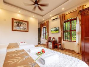 a bedroom with two beds and a ceiling fan at Lys Homestay in Ninh Binh +256 photos