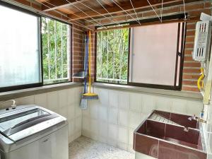 a bathroom with a sink and windows in it at New apart steps from CC Mayorca in Sabaneta +30 photos
