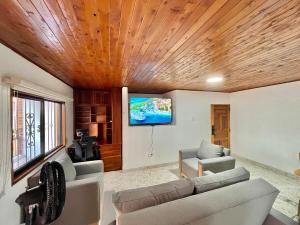 a living room with a couch and a flat screen tv at New apart steps from CC Mayorca in Sabaneta