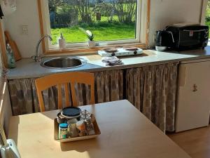 a kitchen with a sink and a table with a tray on it at 5 star holiday home in Odder in Gylling
