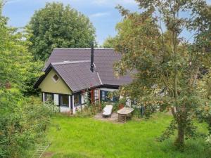 a small house with a table in a yard at 5 star holiday home in Vesterborg in Vesterborg
