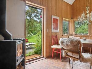 a room with a fireplace and a table and a dining room at 5 star holiday home in Vesterborg in Vesterborg