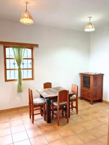 a dining room with a table and chairs and a window at View of Atitlán Private apartment with balcony in Sololá