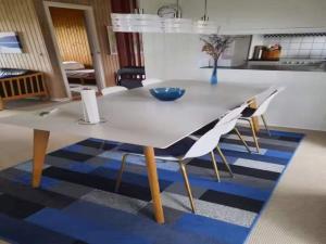 a dining room table with two chairs and a table at 5 star holiday home in Ørsted in Udbyhøj +12 photos