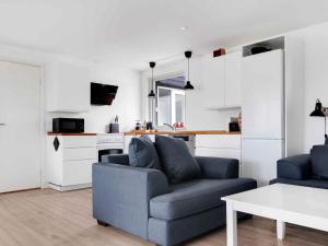 a living room with a couch and a table at 5 star holiday home in Vig in Glostrup