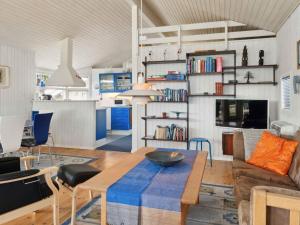 a living room with a table and a couch at 5 star holiday home in Strøby in Strøby Ladeplads