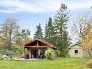 a small house in the middle of a field at 5 star holiday home in Nykøbing Sj in Nyrup