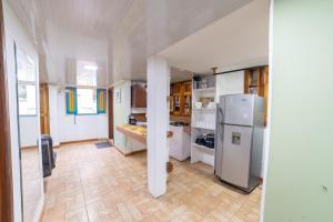 a kitchen with a refrigerator and a table in it at Calle Real House in Salento