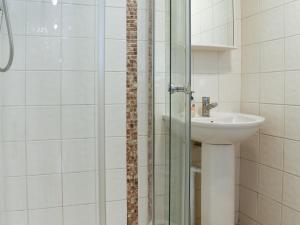 a bathroom with a sink and a glass shower at The Secret Garden in Windermere +3 photos