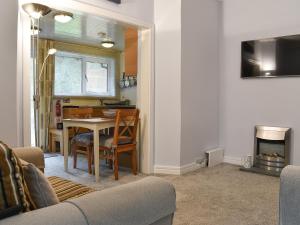 a living room with a table and a dining room at The Secret Garden in Windermere