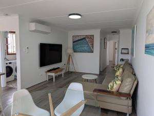 a living room with a couch and a table at Beachside Nook at Warilla in Lake Illawarra