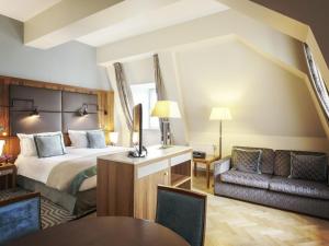 a hotel room with a bed and a couch at Sofitel Grand Sopot in Sopot +130 photos