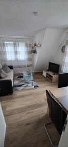 a living room with a couch and a table at Monteurs-Ferienwohnung in Emden