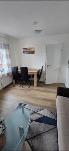 a living room with a glass table and chairs at Monteurs-Ferienwohnung in Emden