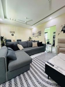 a living room with a couch and a table at WanZa House in Bachok