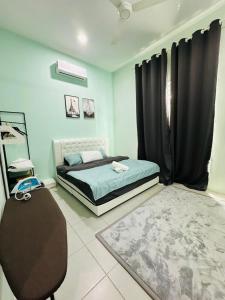 a bedroom with a bed and a chair in it at WanZa House in Bachok +10 photos