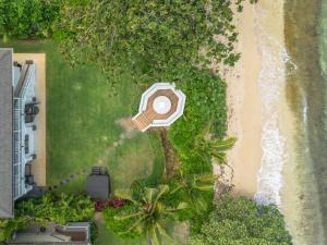 an aerial view of a beach with a house at The Emerald Surf House I home in Waialua