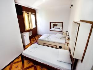 a hospital room with two beds and a mirror at Don Carlo Hotel in São Bernardo do Campo