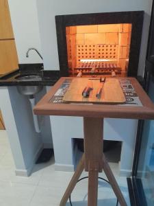 a table with a model of a kitchen with a sink at Ap 440 m do mar, próx Beto Carrero in Navegantes