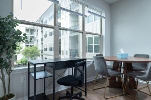 a dining room with a table and chairs and a window at Central 1-BR Condo Assembly Row Gym & Pool Sleep 5 in Winter Hill