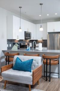 a living room with a couch and a kitchen at Central 1-BR Condo Assembly Row Gym & Pool Sleep 5 in Winter Hill +65 photos