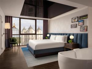 a hotel room with a bed and a large window at The Starling Atlanta Midtown, Curio Collection by Hilton in Atlanta