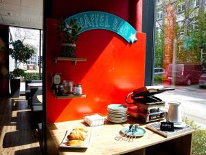 a sandwich shop with a sign on the wall at ibis Köln Messe in Cologne