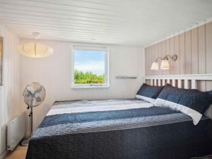 a bedroom with a large bed and a window at 5 star holiday home in Karrebæksminde in Karrebæksminde